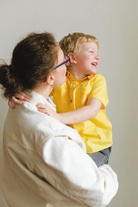 Buffalo Grove Parenting Plan Lawyer woman carrying boy wearing yellow polo shirt 3905790 200x300